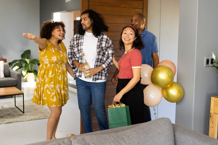Friends celebrating at home with balloons and gifts, smiling and enjoying together. Celebration, party, friendship, happiness, gathering, togethernessの写真素材