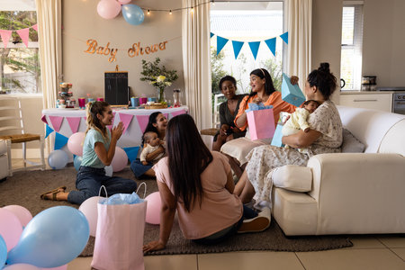 Women celebrating baby shower at home, exchanging gifts and enjoying conversation. Celebration, gathering, friendship, maternity, happiness, bondingの写真素材