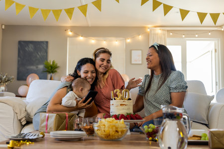 Friends celebrating birthday with cake and gifts, smiling and enjoying together. Celebration, party, friendship, happiness, laughter, festiveの写真素材