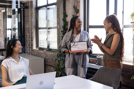 African American woman receiving award in office, colleagues applauding and smiling. Diversity, achievement, recognition, success, celebration, teamworkの写真素材