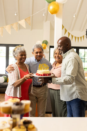 Celebrating 60th birthday with cake and balloons, family sharing joyful moments together. Celebration, milestone, happiness, family gathering, birthday party, togethernessの写真素材