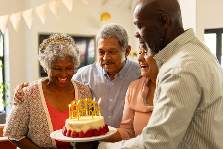 Celebrating birthday, African American family with cake, smiling happily together. celebration,...