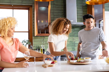 Preparing meal in modern kitchen, Diverse friends sharing conversation and laughter together....