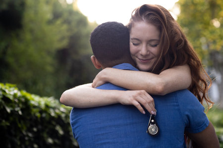 Embracing outdoors, couple with woman holding keychain and smiling warmly. happiness, love, relationship, nature, adventure, togethernessの写真素材