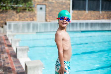 Lap pool lanes glistening under bright sun on brick-paved deck with metal railing, starting blocks. Sports, recreation, aquatic, summer, leisure, athletic, outdoorの写真素材