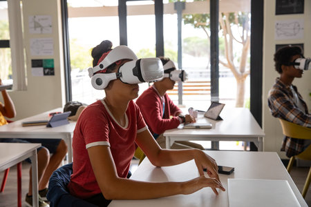 Diverse students using VR headsets training on technology at lab tables with laptops, copy space....