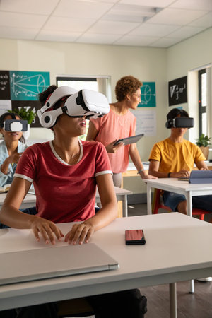 Asian teenage boy in red t-shirt using virtual reality headset at classroom desk with math boards....