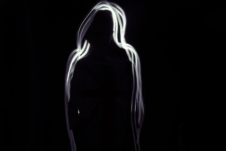 Shadow Girl  A silhouette of a girl on a black background. Glow whitepurple line is around her.