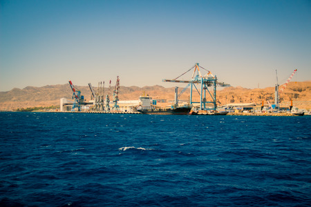 Port of Eilat Israel. A cargo ship docked in the port Long shot.の写真素材