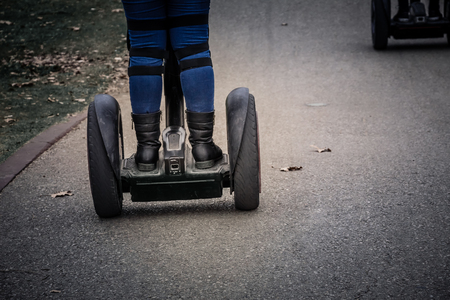 Woman riding on a Segway in the parkの写真素材