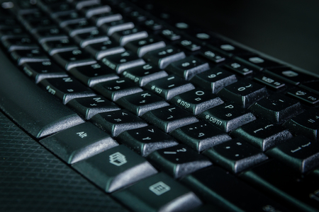 Keyboard with letters in Hebrew and English - Wireless keyboard - Close up - Dark atmosphereの写真素材