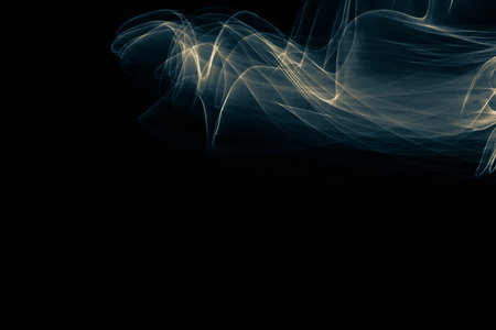 Light painted glowing abstract blue and yellow curved lines on a black background