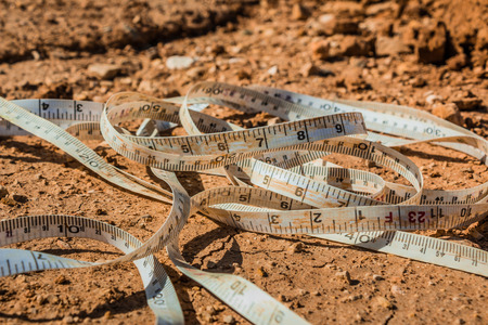 Measuring tape placed on the ground at a construction site.の写真素材