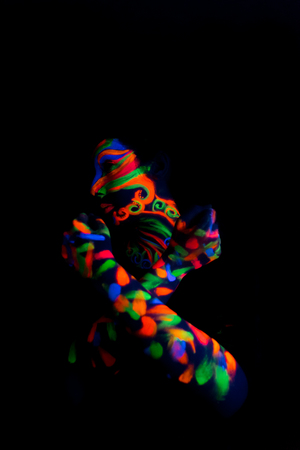 Woman with make up art of glowing UV fluorescent powder.の写真素材