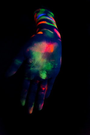Woman with make up art of glowing UV fluorescent powder.の写真素材