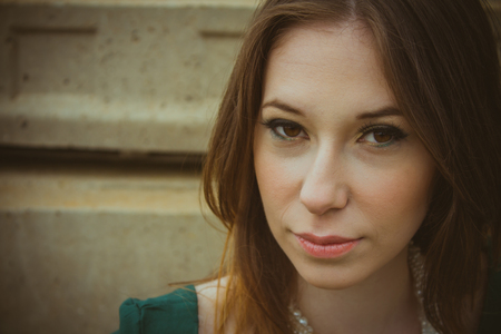 Beautiful brunette woman posing outdoor in abandoned industrial place - dark mysterious artistic portrait.の写真素材