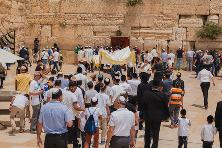 Jerusalem, Israel - May 9, 2016: Jewish worshipers gather for a Bar Mitzvah ritual at the Western...