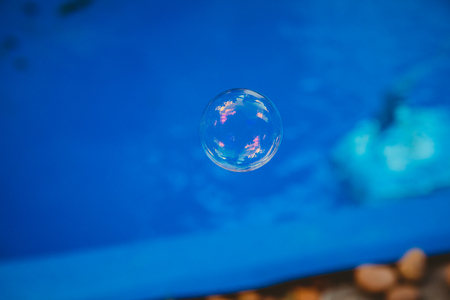 Soap bubbles fly in the swimming pool.