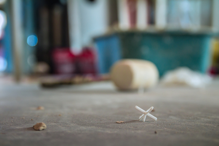 Closeup on floor in construction site. Wooden hammer in blur background.の写真素材