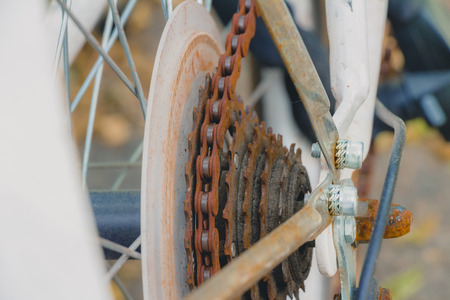 Old rusty chain on white bicycle. Selective focus close up.の写真素材