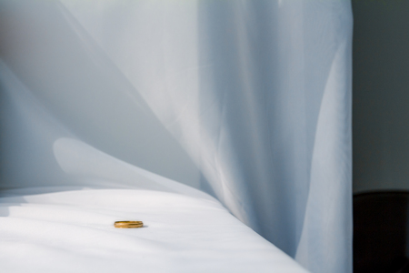 Man wedding ring on white cloth background.の写真素材