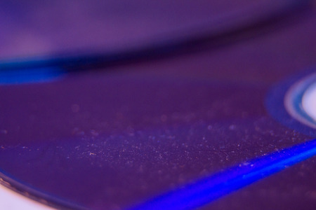 Macro closeup of Compact CD or DVD disc in violet color.