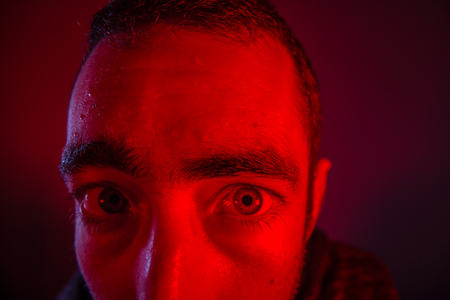 Sweating man looked sick or stoned. Close up headshot portrait of man having fever or drugged him or poisoned him.の写真素材