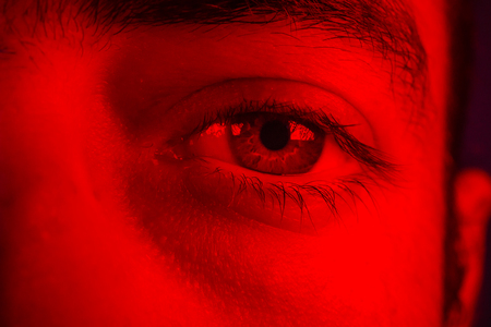 Macro on man eye expressing serious and expressionless expression.の写真素材