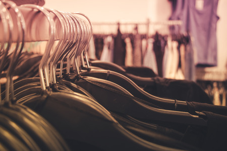 Close up of many clothes on hangers in a clothing shop.の写真素材