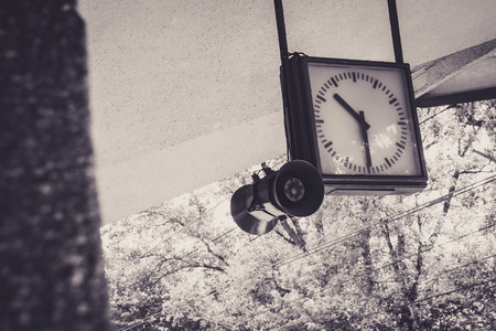 An old railway station clock in Warsaw Poland. In sepia tone color.の写真素材