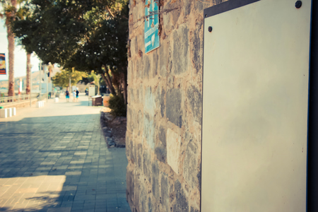 A blank sign on ancient brick wall at the Tiberias promenade.の写真素材