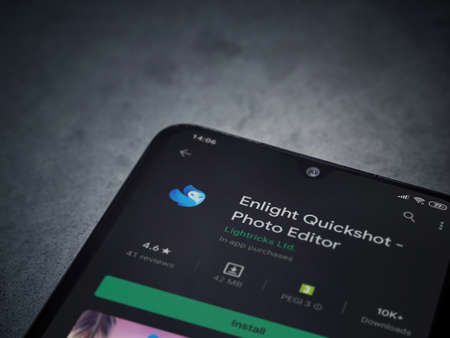 Lod, Israel - July 8, 2020: Enlight Quickshot app play store page on the display of a black mobile smartphone on a dark marble stone background. Top view flat lay with copy space.のeditorial素材