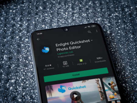 Lod, Israel - July 8, 2020: Enlight Quickshot app play store page on the display of a black mobile smartphone on a metallic background. Close up top view flat lay.のeditorial素材