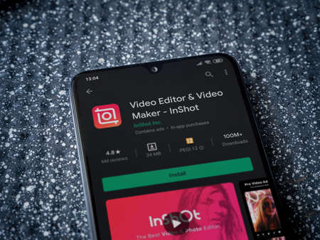 Lod, Israel - July 8, 2020: InShot - Video Editor and Movie Maker app play store page on the display of a black mobile smartphone on a metallic background. Close up top view flat lay.のeditorial素材