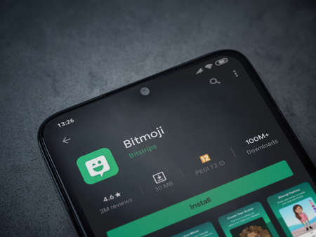 Lod, Israel - July 8, 2020: Botmoji app play store page on the display of a black mobile smartphone on dark marble stone background. Top view flat lay with copy space.のeditorial素材