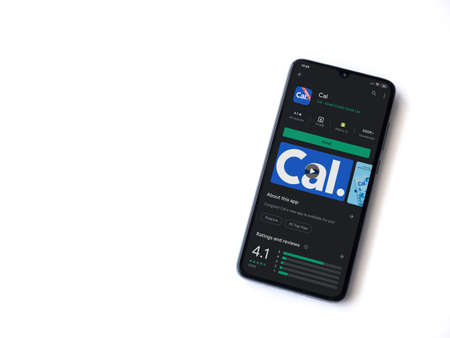 Lod, Israel - July 8, 2020: Cal app play store page on the display of a black mobile smartphone isolated on white background. Top view flat lay with copy space.のeditorial素材