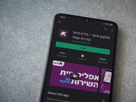 Lod, Israel - July 8, 2020: Cellcom app play store page on the display of a black mobile smartphone on ceramic stone background. Top view flat lay with copy space.のeditorial素材