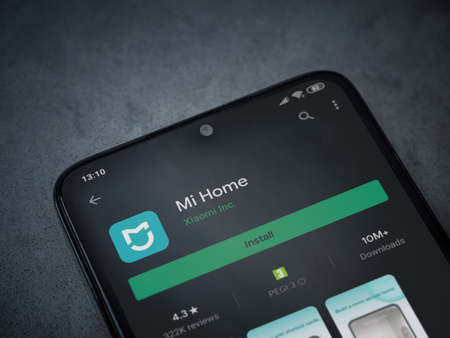 Lod, Israel - July 8, 2020: Mi Home app play store page on the display of a black mobile smartphone on dark marble stone background. Top view flat lay with copy space.のeditorial素材