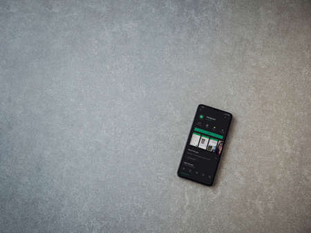 Lod, Israel - July 8, 2020: Hanghouts app play store page on the display of a black mobile smartphone on ceramic stone background. Top view flat lay with copy space.のeditorial素材