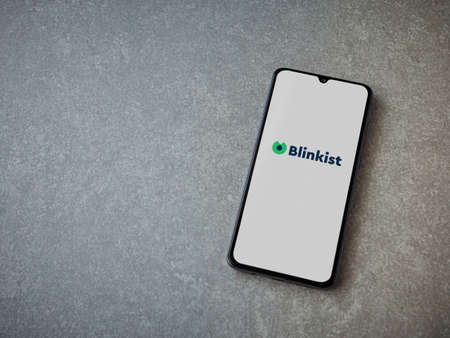 Lod, Israel - July 8, 2020: Blinkist app launch screen with logo on the display of a black mobile smartphone on ceramic stone background. Top view flat lay with copy space.のeditorial素材