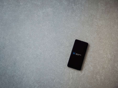 Lod, Israel - July 8, 2020: Adobe Lightroom - Photo Editor and Pro Camera app launch screen with logo on the display of a black mobile smartphone on ceramic stone background. Top view flat lay with copy space.のeditorial素材