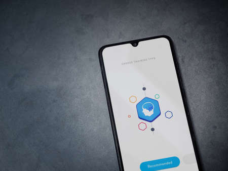 Lod, Israel - July 8, 2020: Elevate - Brain training games app launch screen with logo on the display of a black mobile smartphone on a dark marble stone background. Top view flat lay with copy space.のeditorial素材