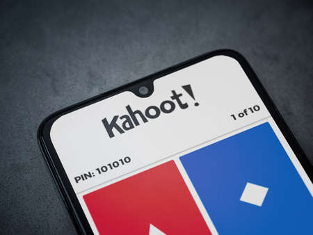 Lod, Israel - July 8, 2020: Kahoot! app launch screen with logo on the display of a black mobile smartphone on a dark marble stone background. Top view flat lay with copy space.のeditorial素材