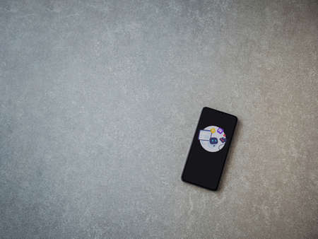 Lod, Israel - July 8, 2020: Mimo - Learning coding app launch screen with logo on the display of a black mobile smartphone on ceramic stone background. Top view flat lay with copy space.のeditorial素材