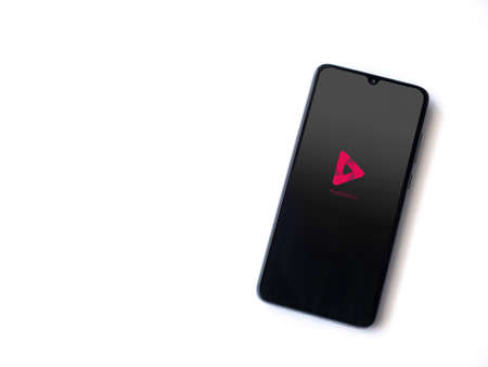 Lod, Israel - July 8, 2020: PixaMotion app launch screen with logo on the display of a black mobile smartphone isolated on white background. Top view flat lay with copy space.のeditorial素材