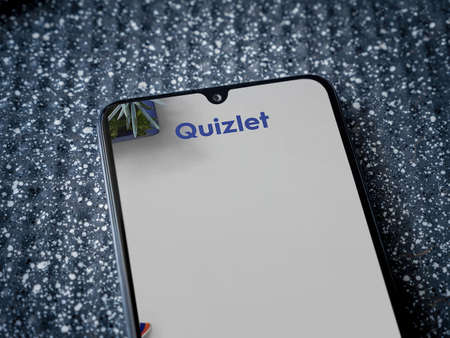 Lod, Israel - July 8, 2020: Quizlet - Language learning app launch screen with logo on the display of a black mobile smartphone on a metallic background. Close up top view flat lay.のeditorial素材