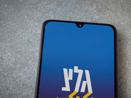 Lod, Israel - July 8, 2020: Galgalatz app launch screen with logo on the display of a black mobile...