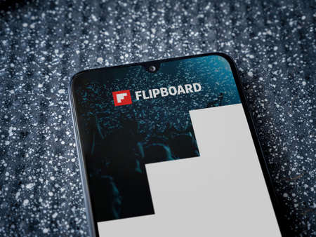 Lod, Israel - July 8, 2020: Flipboard app launch screen with logo on the display of a black mobile...