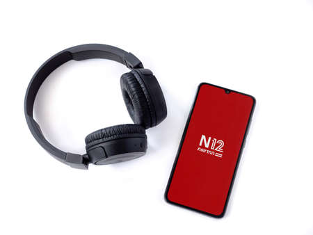 Lod, Israel - July 8, 2020: Black mobile smartphone with N12 app launch screen with logo and...