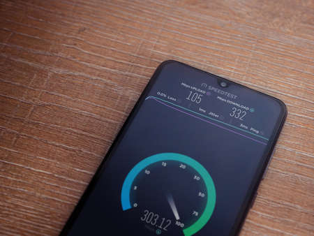 Lod, Israel - July 8, 2020: Speedtest app launch screen with logo on the display of a black mobile...